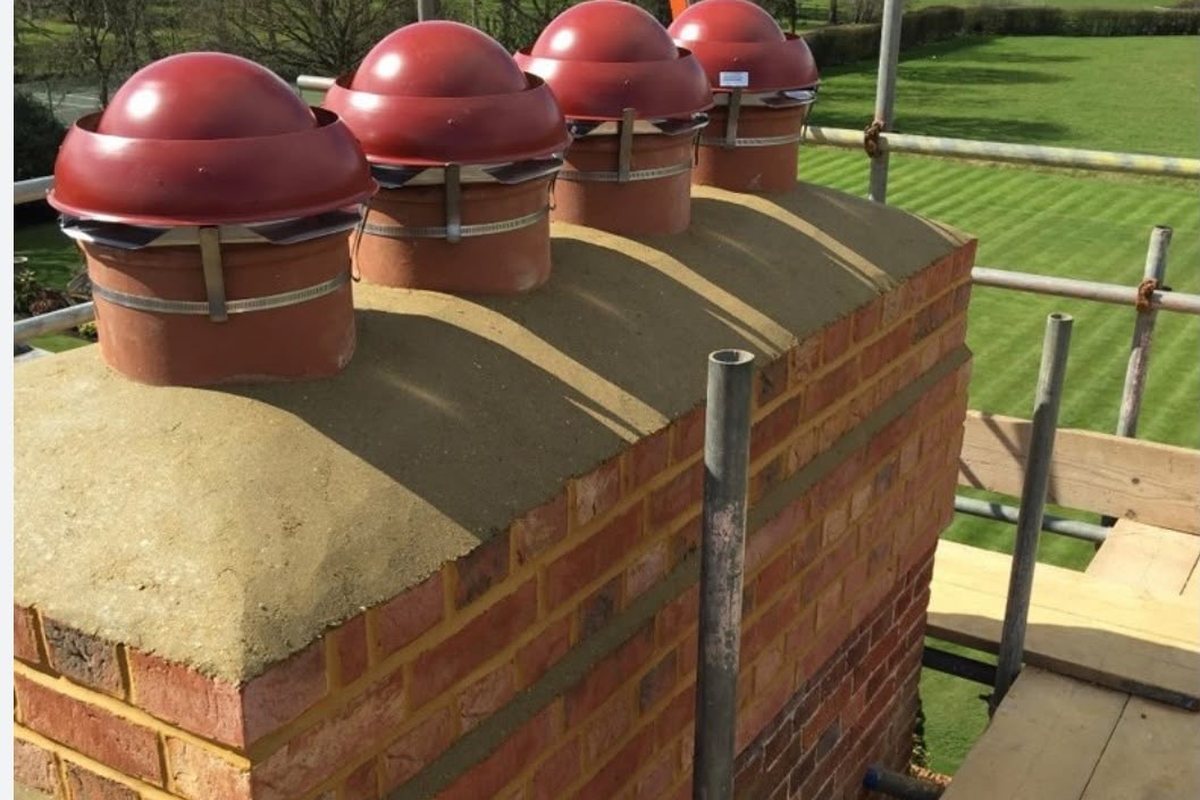 New chimney pots set on a rebuilt stack