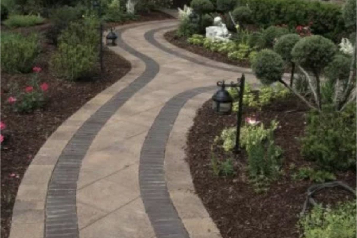 Curved paved path through a landscaped garden