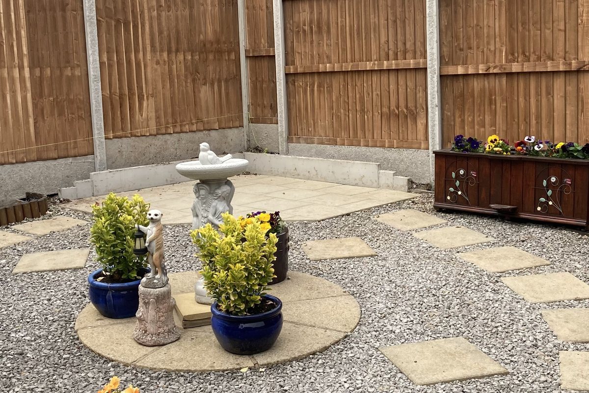 Paved patio with gravel borders and fencing