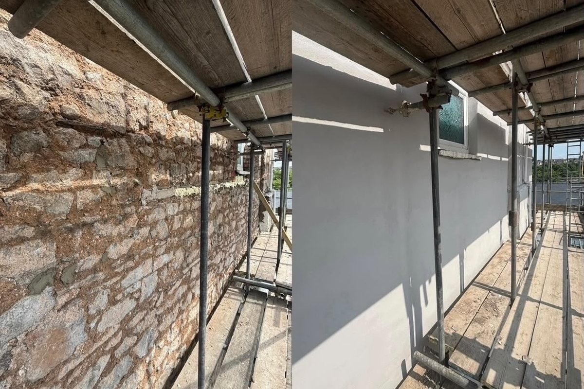 Stone wall rendered to a smooth finish